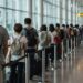 people waiting in line at the airport for security check